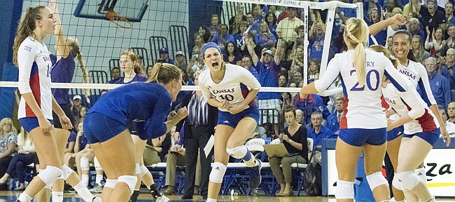 Kansas junior Tayler Soucie (10) celebrates with her teammates after making a kill during the Jayhawks' volleyball match against in-state rival Kansas State Wednesday evening at the Horejsi Center. The Jayhawks bested the Wildcats, 3-1, and improved to 13-0 on the year. 