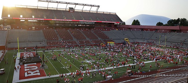 Fans crowd onto the field during a party at Rutgers’ football stadium in this photo from July 1, 2014, in Piscataway, New Jersey. Rutgers, which bills itself as the “Birthplace of College Football,” will host Kansas University on Saturday.