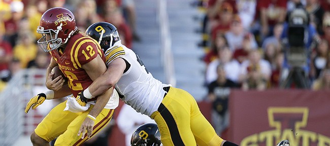 Iowa State quarterback Sam B. Richardson (12) is sacked by Iowa's Parker Hesse and Nate Meier, right, during the second half their game Saturday, Sept. 12, 2015, in Ames, Iowa. 