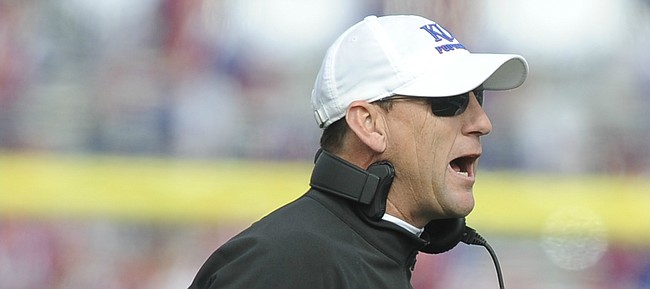 Kansas head coach David Beaty gives some instruction to his players during the third quarter on Saturday, Oct. 17, 2015 at Memorial Stadium.