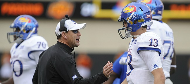 Kansas head coach David Beaty gives quarterback Ryan Willis a pat after a three and out during the second quarter on Saturday, Oct. 24, 2015 at T. Boone Pickens Stadium in Stillwater, Okla.