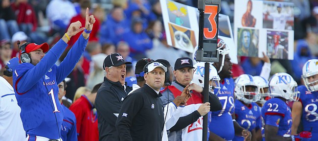 With the game well out of hand Kansas head coach David Beaty looks at the video board during the fourth quarter, Saturday, Oct. 31, 2015 at Memorial Stadium.
