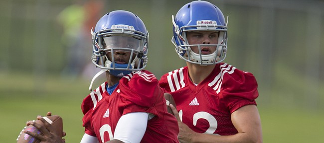 Kansas quarterbacks Montell Cozart (2) and Ryan Willis (13) look up the field for receivers during the first day of practice on Thursday, Aug. 6, 2015 at the fields south of Anschutz Pavilion.