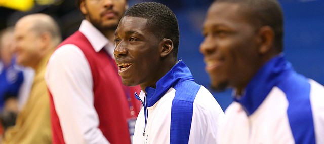 Kansas freshman Cheick Diallo, center, laughs with Dwight Coleby as they watch warmups prior to tipoff, Friday, Nov. 13, 2015 at Allen Fieldhouse.