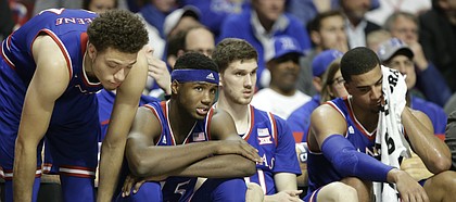 Kansas players Brannen Greene, left, Carlton Bragg Jr., Sviatoslav Mykhailiuk and Landen Lucas watch from the bench as Michigan State widens its lead late in the second half, Tuesday, Nov. 17, 2015 at United Center in Chicago.