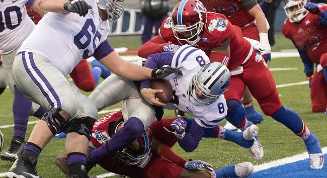 Kansas' Marcquis Roberts, right, and Fish Smithson are unable to keep Kansas State junior quarterback Joe Hubener (8) out of the end zone during the annual Sunflower Showdown game Saturday at Memorial Stadium.