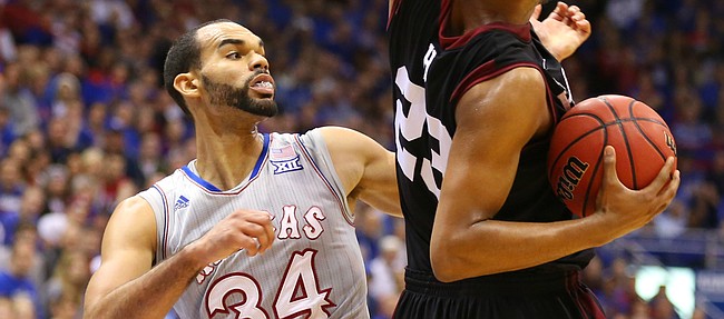 Kansas forward Perry Ellis (34) looks to strip away a ball from Harvard forward Weisner Perez (23) during the second half, Saturday, Dec. 5, 2015 at Allen Fieldhouse.