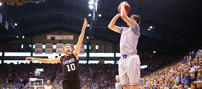 Kansas guard Sviatoslav Mykhailiuk (10) pulls up from the corner for three against Harvard guard Patrick Steeves (10) during the first half, Saturday, Dec. 5, 2015 at Allen Fieldhouse.