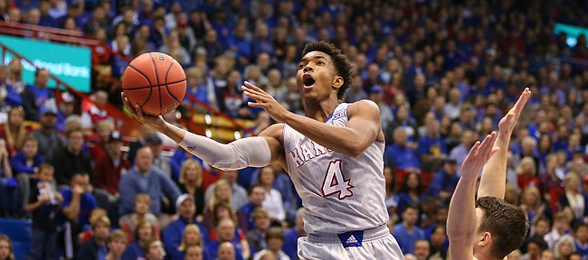 Kansas guard Devonte' Graham (4) extends for a bucket in transition against Harvard guard Tommy McCarthy (3) during the first half, Saturday, Dec. 5, 2015 at Allen Fieldhouse.