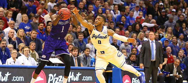 Kansas guard Frank Mason III (0) nearly intercepts a pass to Holy Cross forward Karl Charles (1) during the first half, Wednesday, Dec. 9, 2015 at Allen Fieldhouse.