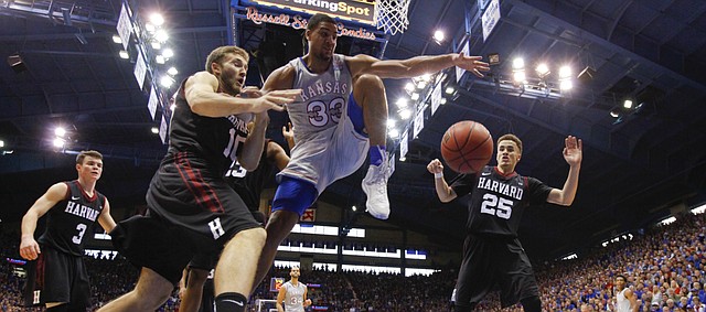 Kansas forward Landen Lucas (33) fights for a loose ball with Harvard guard Patrick Steeves (10) under the bucket during the second half, Saturday, Dec. 5, 2015 at Allen Fieldhouse.