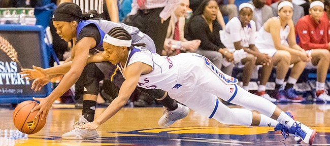 UMKC sophomore guard Daijane Dillard, left, is quicker to the ball as she and Kansas junior guard Timeka O'Neal duel for possession of a loose ball during their game Thursday evening at Allen Fieldhouse. 