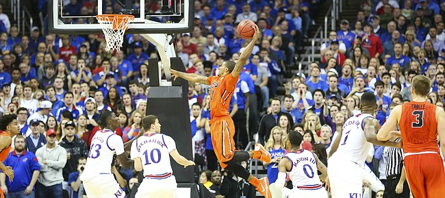 Oregon State guard Gary Payton II (1) elevates for a thunderous dunk against Kansas forward Cheick Diallo (13) and guard Sviatoslav Mykhailiuk (10) during the first half, Saturday, Dec. 12, 2015 at Sprint Center.
