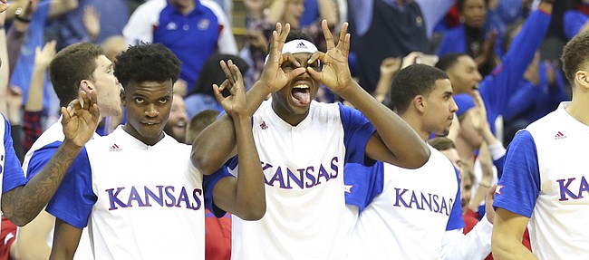 Kansas forward Carlton Bragg Jr. puts up a pair of three goggles as the Jayhawk bench celebrates a three-pointer by Perry Ellis during the second half, Saturday, Dec. 12, 2015 at Sprint Center.
