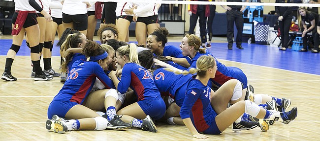 Kansas University volleyball players dog-pile after their five-set victory over USC on Saturday, Dec. 12, 2015, in San Diego.