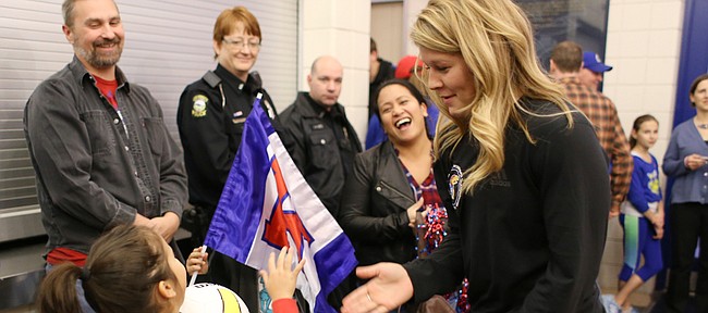 Kansas junior volleyball player Cassie Wait, right, greets Alyssa Bobcock, 5, Topeka, and her family as fans welcomed the national semifinalist Kansas volleyball team back to campus and the Horejsi Family Athletics Center Friday evening, Dec. 18, 2015. The Kansas women’s team completed a season that included a program-record .909 winning percentage (30-3), two Jayhawks earning AVCA All-America First Team honors, and the best postseason finish in program history (NCAA semifinals).