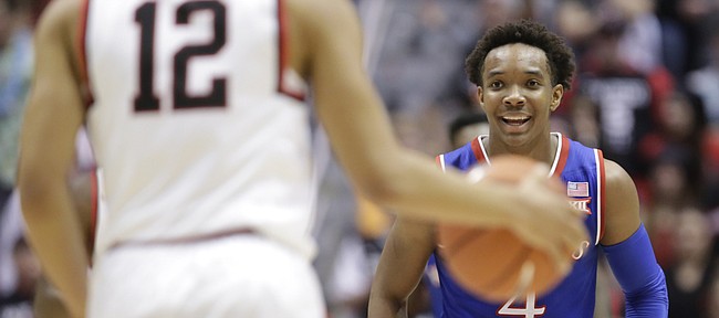 Kansas guard Devonte' Graham (4) flashes a smile during a run by the Jayhawks.