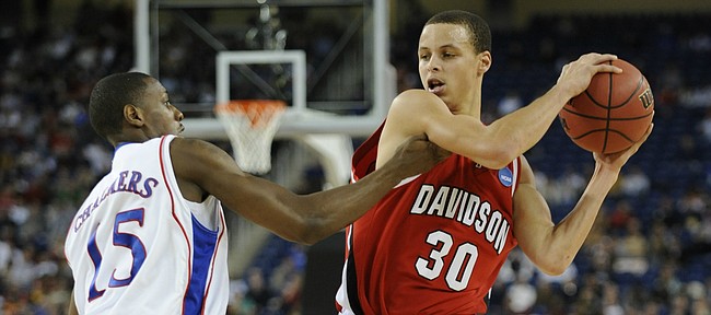 Kansas' Mario Chalmers defends Davidson's Stephen Curry on Sunday, March 30, 2008 in Detroit, Mich.
