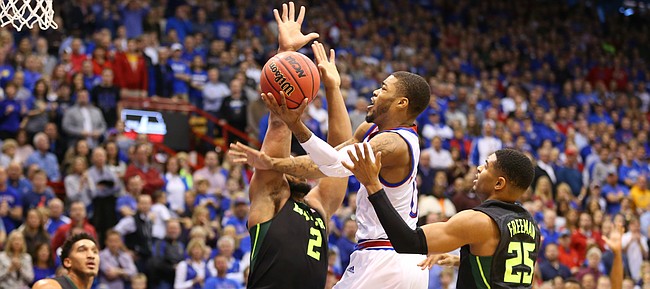 Kansas guard Frank Mason III (0) hangs for a shot in the lane against Baylor forward Rico Gathers (2) and guard Al Freeman (25) during the first half, Saturday, Jan. 2, 2016 at Allen Fieldhouse.