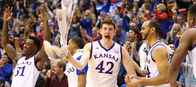 Kansas forward Hunter Mickelson (42) and the Jayhawk bench celebrate a three by Lagerald Vick during the second half, Saturday, Jan. 2, 2016 at Allen Fieldhouse.
