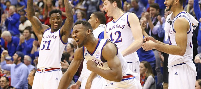 Kansas guard Wayne Selden Jr. (1) pumps his fist in celebration with the Jayhawks' bench after a late three by teammate Lagerald Vick during the second half, Saturday, Jan. 2, 2016 at Allen Fieldhouse.