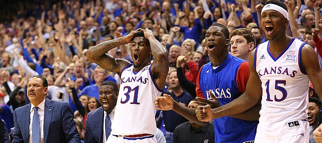 Kansas forward Jamari Traylor (31), forward Cheick Diallo (13) and forward Carlton Bragg Jr. (15) react to an and-one bucket by guard Devonte' Graham (4) to tie the game during the second half, Monday, Jan. 4, 2016 at Allen Fieldhouse.