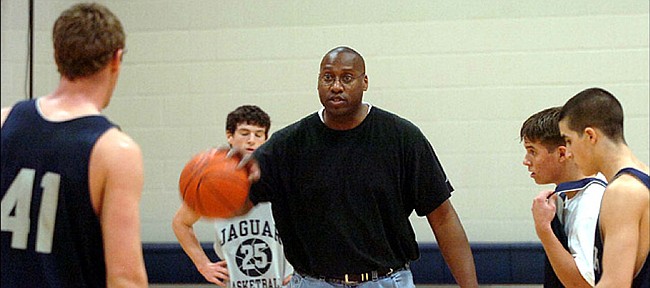 Former Jayhawk basketball player Alonzo Jamison runs a 2006 Mill Valley practice.
