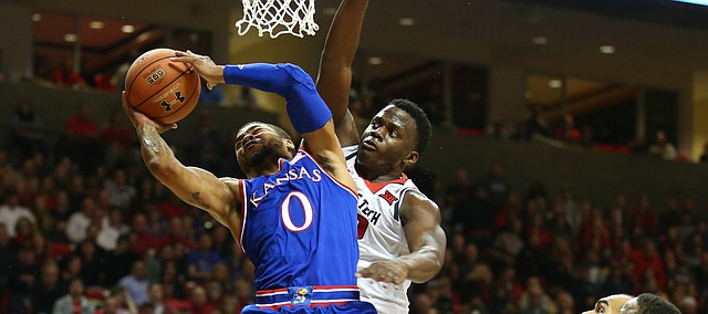 Kansas guard Frank Mason III (0) is fouled on his way up to the bucket by Texas Tech center Norense Odiase (32) during the first half, Saturday, Jan. 9, 2016 at United Spirit Arena in Lubbock, Texas.