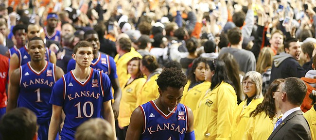 Kansas guard Devonte' Graham and the rest of the Jayhawks leave the floor following their 86-67 loss to Oklahoma State on Tuesday, Jan. 19, 2016 at Gallagher-Iba Arena in Stillwater, Okla.