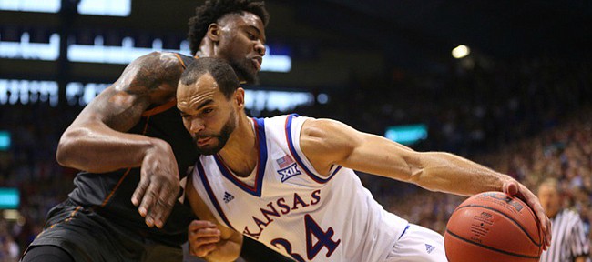 Kansas forward Perry Ellis (34) bangs into Texas center Prince Ibeh as he heads to the bucket during the second half, Saturday, Jan. 23, 2016 at Allen Fieldhouse.