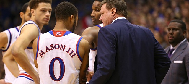 Kansas head coach Bill Self checks on point guard Frank Mason III (0) after Mason went down holding his elbow during the second half, Saturday, Jan. 23, 2016 at Allen Fieldhouse.