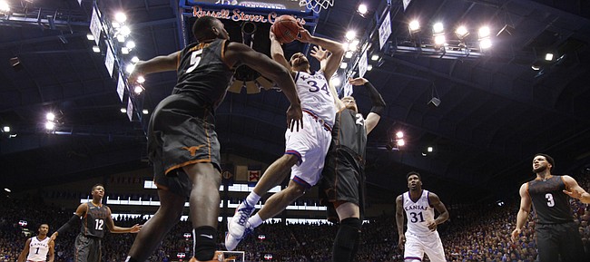 Kansas forward Perry Ellis (34) gets in for a bucket against Texas forward Connor Lammert (21) during the second half, Saturday, Jan. 23, 2016 at Allen Fieldhouse.