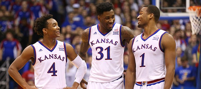 Kansas guard Devonte' Graham (4), forward Jamari Traylor (31) and guard Wayne Selden Jr. (1) have a laugh with the game wrapped up and seconds remaining, Saturday, Jan. 23, 2016 at Allen Fieldhouse.