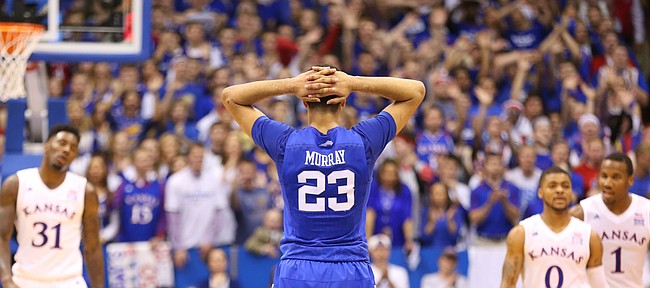 Kentucky guard Jamal Murray (23) holds his head in his hands after Kentucky forward Derek Willis (35) fouled out during overtime, Saturday, Jan. 30, 2016 at Allen Fieldhouse.
