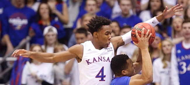 Kansas guard Devonte' Graham (4) gets over the top of Kentucky guard Isaiah Briscoe (13) during the first half, Saturday, Jan. 30, 2016 at Allen Fieldhouse.
