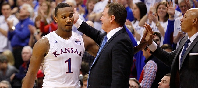 Kansas coach Bill Self gives a congratulatory slap to Kansas guard Wayne Selden Jr. (1) as Selden leaves the game with little time remaining, Saturday, Jan. 30, 2016 at Allen Fieldhouse.