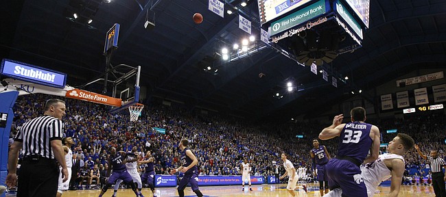 Kansas guard Brannen Greene watches his three from the corner go in as he is fouled by Kansas State guard Brian Rohleder (33) with second remaining in the first half on Wednesday, Feb. 3, 2016 at Allen Fieldhouse. Greene hit the free throw to complete the four-point play.
