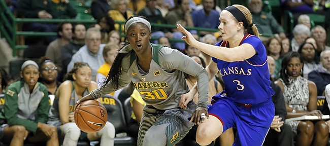 Baylor’s Alexis Jones, left, drives against Kansas’ Lauren Aldridge. Baylor defeated the Jayhawks, 81-49, in a Big 12 women’s basketball game Saturday in Waco, Texas.