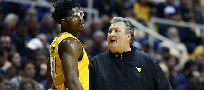 West Virginia head coach Bob Huggins talks to Devin Williams During Saturday’s game with Baylor.