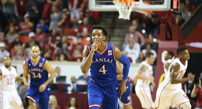 Kansas guard Devonte' Graham (4) shushes the crowd after hitting a three during the first half, Saturday, Feb. 13, 2016 at Lloyd Noble Center in Norman, Okla.