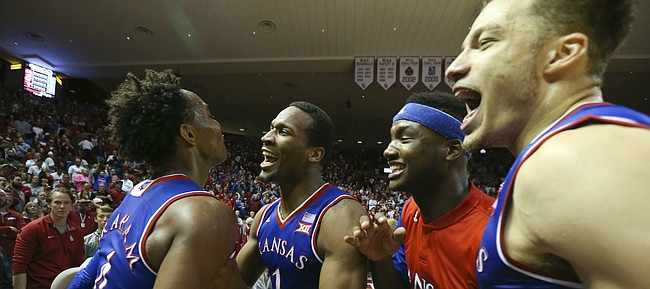 Kansas players from right, Brannen Greene, Carlton Bragg and Wayne Selden come to celebrate with Devonte Graham after Graham held strong late in the game with a few clutch buckets to lift the Jayhawks over the Sooners 76-72, Saturday, Feb. 13, 2016 at Lloyd Noble Center in Norman, Okla.