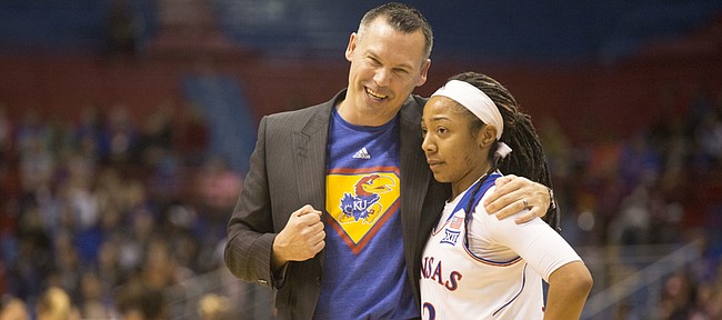 Kansas coach Brandon Schneider pulls Timeka O'Neal aside for a talk after she committed an unforced turnover during their game against Oklahoma State on Sunday afternoon at Allen Fieldhouse. The Jayhawks suffered their 10th consecutive loss, falling to Oklahoma State, 74-46.