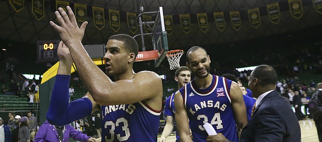 Kansas forward Landen Lucas (33) claps as he leaves the court to the applause of a handful of Jayhawk fans following their 66-60 win over Baylor, Tuesday, Feb. 23, 2016 at Ferrell Center in Waco, Texas. At right is Kansas forward Perry Ellis (34).
