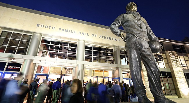 Fans file through the doors of Allen Fieldhouse past the statue of Phog Allen in this file photo from Monday, Oct. 27, 2014.