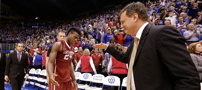 Kansas head coach Bill Self comes in to slap hands and hug Oklahoma guard Buddy Hield (24) following the Jayhawks' 109-106 triple overtime win over the Sooners.
