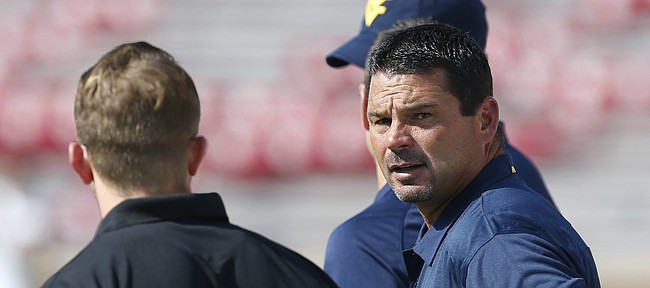West Virginia associate head coach/special teams coordinator Joe DeForest talks on the sidelines before the start of an NCAA college football game against Oklahoma in Norman, Okla., on Sept. 7, 2013.