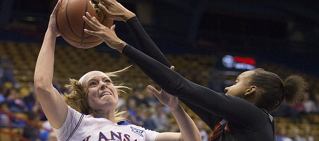 Kansas sophomore Lauren Aldridge (3) is harassed by Texas Tech's Rayven Brooks (11) as she tries to get off a shot during their game Saturday evening at Allen Fieldhouse.