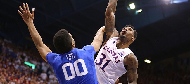 Kansas forward Jamari Traylor (31) hooks a shot over Kentucky forward Marcus Lee (00) for a foul late in the second half, Saturday, Jan. 30, 2016 at Allen Fieldhouse.