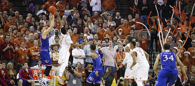 Kansas guard Brannen Greene (14) puts up a three from the corner over Texas guard Isaiah Taylor (1) during the second half, Saturday, Jan. 24, 2015 at Frank Erwin Center in Austin, Texas.