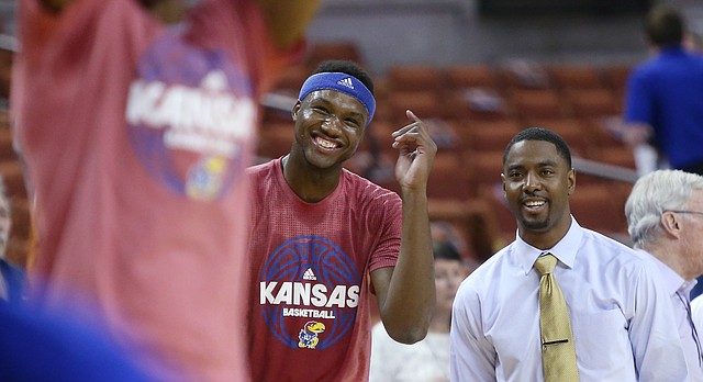 Kansas forward Carlton Bragg Jr. (15), center visits with former KU guard and assistant director of student-athlete developmen, Aaron Miles prior to the start of KU's game against the Texas Longhorns Monday, Feb. 29, 2016 at the Frank Erwin Center in Austin, Texas. 
